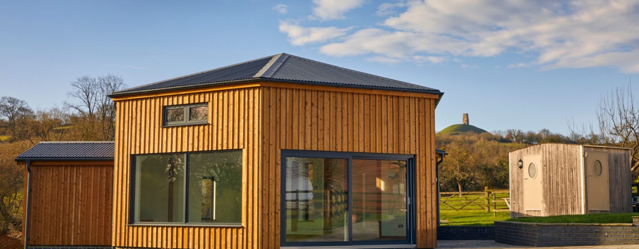 Exterior of our hexagonal group space with Glastonbury Tor in the background
