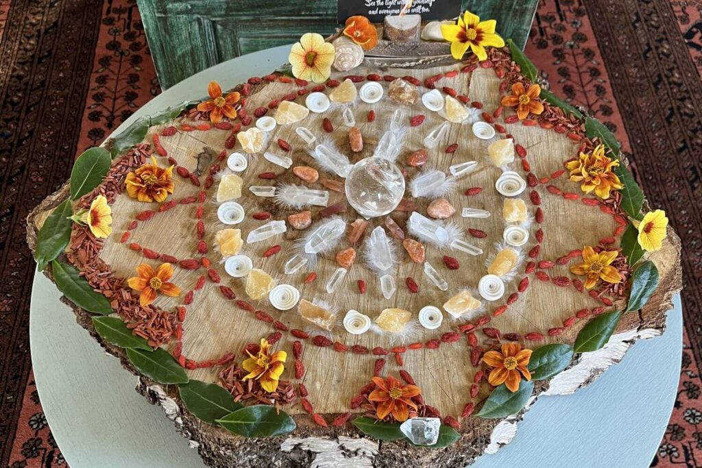 A mandala made of flowers and crystals in summery oranges and yellows