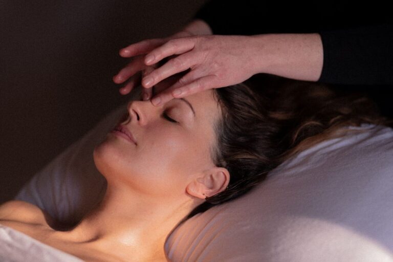 Massage therapist using therapeutic strokes on the bridge of a client's nose