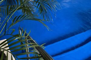 The pool at Middlewick Spa, with a deep blue floor and indoor plants